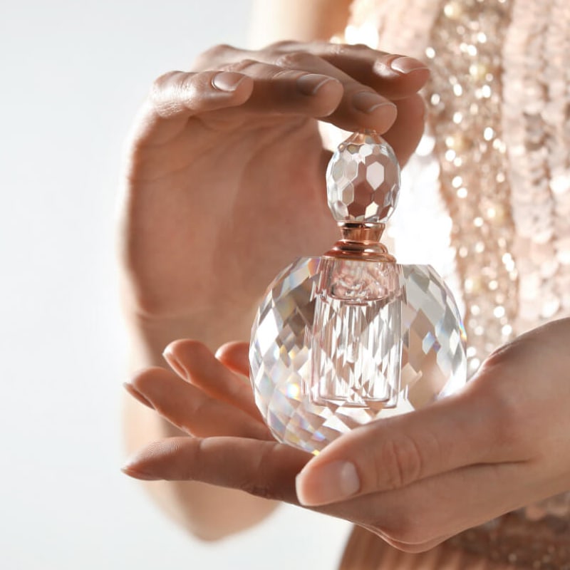 bottle of perfume in a girl's hand